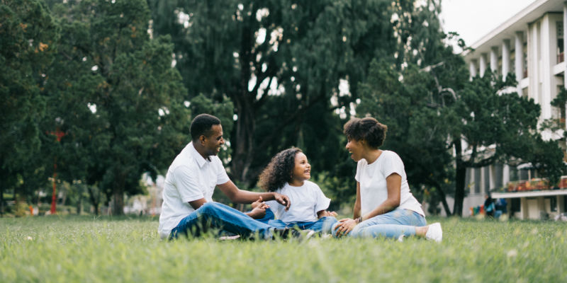 Happy family sitting outside