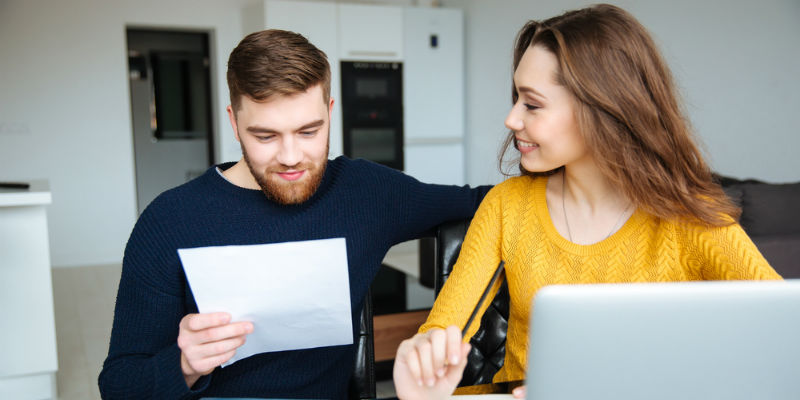 A happy couple looking at paperwork