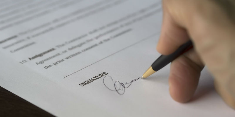 Person signing a contract