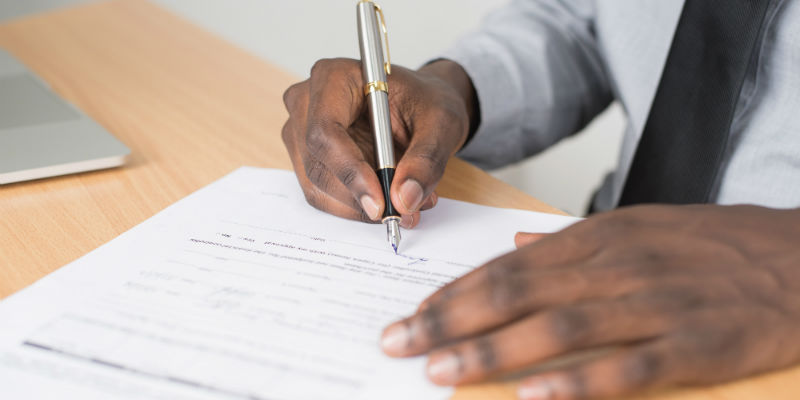 A person signing paperwork