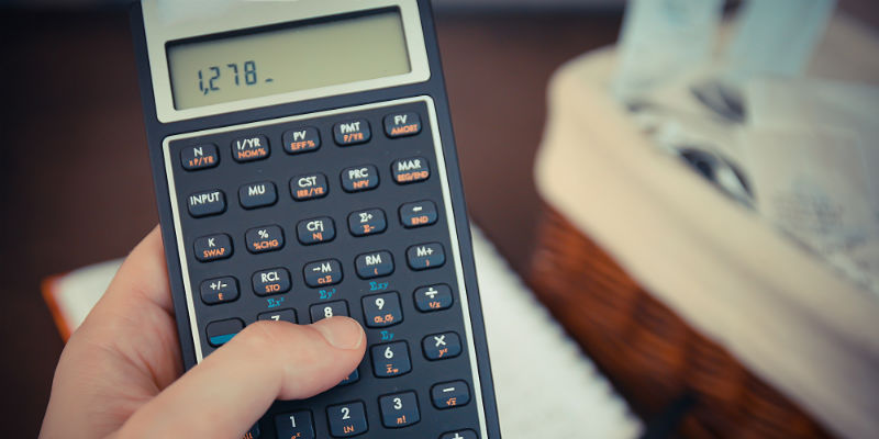 A person holding a calculator 