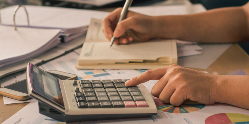 Accountant working on a calculator 
