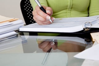 Writing a check on a glass table..jpeg